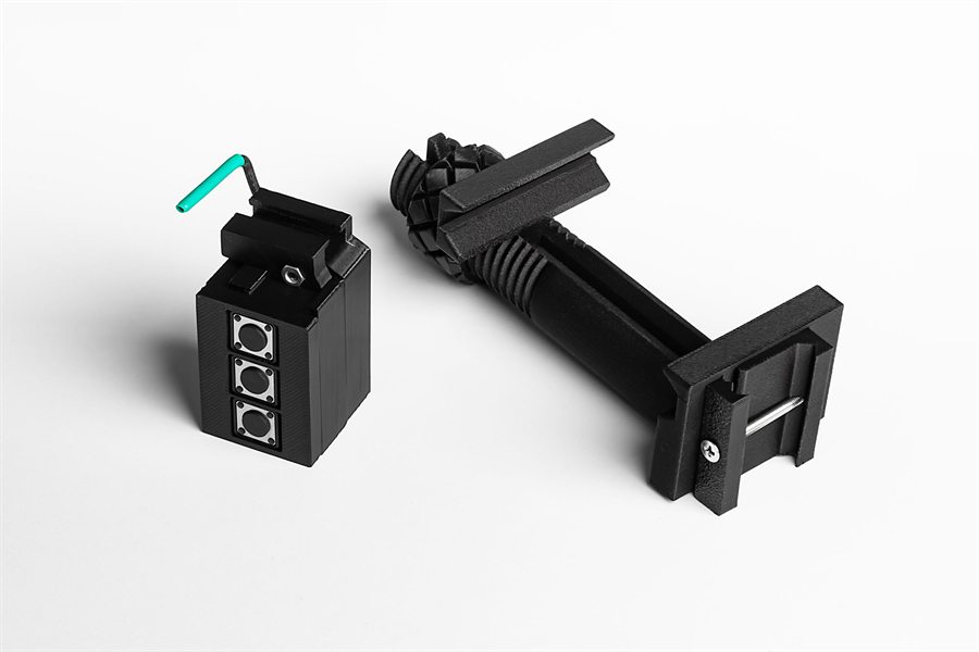 The TRIQ module next to a Picatinny phone mount.